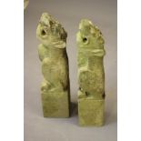 A PAIR OF CARVED SANDSTONE LION GARGOYLES on square bases, 25" x 5 1/2" (Illustrated) (Est. plus 21%
