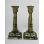 A PAIR OF BURMANTOFTS FAIENCE GREEN GLAZED CANDLESTICKS, early 20th century, the flared palmette
