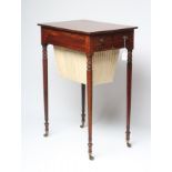 A REGENCY MAHOGANY WORK TABLE of oblong form with ebony stringing, frieze drawer with turned brass