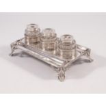 A GEORGE III SILVER DESK STANDISH, maker William Plummer, London 1778, of oblong form with re-