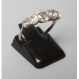 A FIVE STONE DIAMOND RING, the old cut stones claw set to a plain white shank, stamped ?CTW, PT,