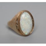 AN OPAL DRESS RING, the oval polished cabochon collet set with three diamond chips to each