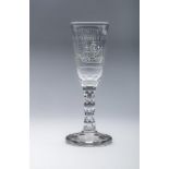 A SMALL GLASS ALE FLUTE, the slightly flared bowl cut and engraved with a two masted sailing ship