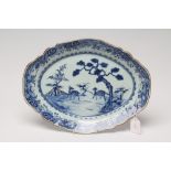 A CHINESE PORCELAIN DISH of lobed oval form, painted in underglaze blue with two spotted deer in