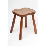 ROBERT THOMPSON, an adzed oak stool, the waisted rounded oblong top with carved mouse trademark in