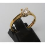 A SOLITAIRE DIAMOND RING, the princess cut stone of 0.33cts point set to a plain 18ct gold shank,