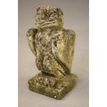 AN ARTS AND CRAFTS STYLE COMPOSITION STONE BIRD modelled standing with folded wings, on square base,