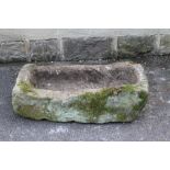 A SANDSTONE TROUGH of rough hewn oblong form, 34 1/2" x 17 1/2" x 10 1/2" (Est. plus 21% premium