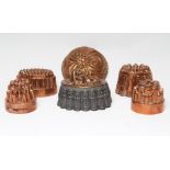 FIVE COPPER JELLY MOULDS, Victorian and later, comprising two ovals, 6" and 6 3/4" wide, two