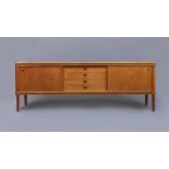 A BRAMIN TEAK LONG SIDEBOARD, 1960's, the moulded edged top over four central recessed drawers