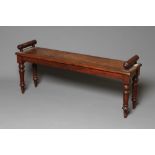 AN EARLY VICTORIAN MAHOGANY HALL BENCH, the moulded edged seat with turned bolsters to either end,