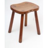 ROBERT THOMPSON, an adzed oak stool, the waisted rounded oblong top with carved mouse trademark in