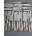A SET OF TWELVE TABLE KNIVES, with Hungarian silver handles, eleven engraved "KA" and steel blades