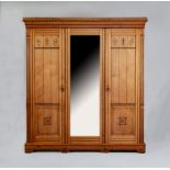 A VICTORIAN AESTHETIC ASH TRIPLE WARDROBE with black painted foliate scrolls and geometric