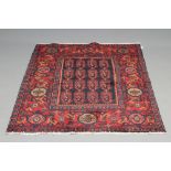 A SENNEH RUG, modern, the dark navy field with repeating boteh pattern in red, green and ivory,