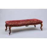 A VICTORIAN WALNUT LARGE STOOL of oblong form upholstered in red and grey cut chenille by Gisbert