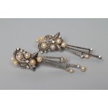 A PAIR OF PEARL AND DIAMOND DROP EARRINGS, the open scroll clips peg set with five graduated