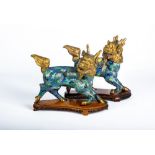 A PAIR OF CHINESE CLOISONNE ENAMEL KYLIN, with cast and engraved gilt metal heads, tails and hooves,