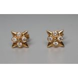 A PAIR OF DIAMOND EAR STUDS, the flower panels each collet set with four small stones to 18ct gold