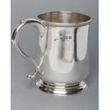 A SILVER MUG, maker Hutton, Birmingham 1912, of plain baluster form with "S" scroll handle on a