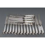 A SET OF EIGHTEEN SILVER TABLE KNIVES, maker C W Fletcher, London 1924, with hollow pistol grip