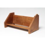 A PETER HEAP OF WETWANG OAK BOOK TROUGH, the sloping ends with carved rabbit trademark in high