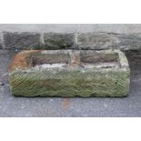 A SANDSTONE TROUGH of fine cut oblong form with central division, 40 1/2" x 17 1/2" x 11" (Est. plus