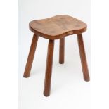 ROBERT THOMPSON, an adzed oak stool, the waisted rounded oblong top with carved mouse trademark in