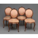 A SET OF FOUR EARLY VICTORIAN WALNUT DINING CHAIRS upholstered in pale pink silk damask, the