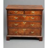 A WALNUT AND FEATHER BANDED STRAIGHT FRONTED CHEST, early 18th century, the banded quartered moulded