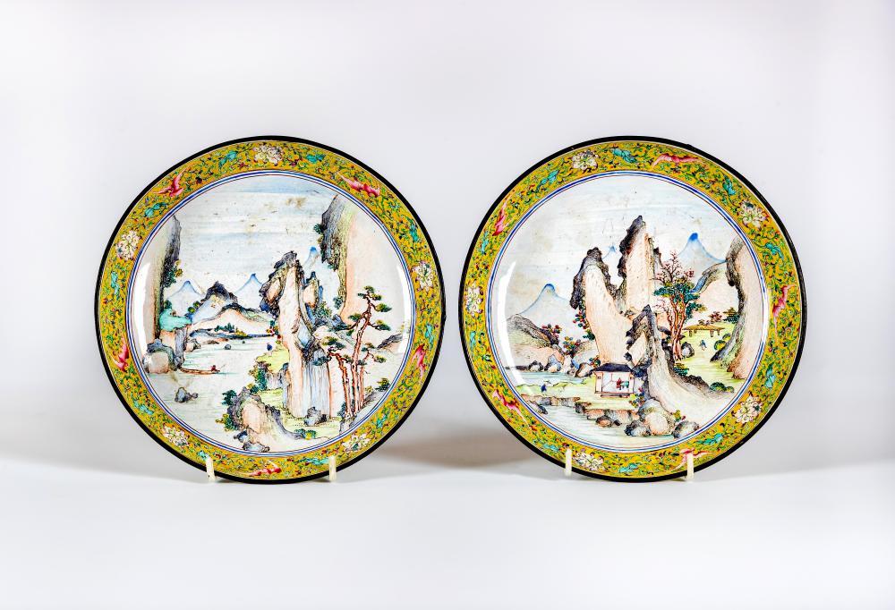 A PAIR OF CANTON ENAMEL SAUCER DISHES centrally painted in pastel colours with figures in