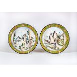 A PAIR OF CANTON ENAMEL SAUCER DISHES centrally painted in pastel colours with figures in