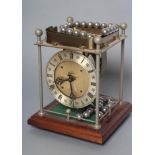 A THWAITES REED ROLLING BALL CLOCK, the open movement with silvered dial and name plaque, four