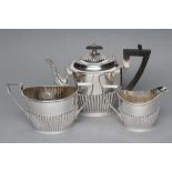 A BACHELOR'S THREE PIECE SILVER TEA SERVICE, maker Walker & Hall, Sheffield 1914 (teapot) and