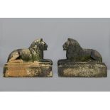 A PAIR OF CARVED STONE RECUMBENT LIONS, mid/late 19th century, modelled Sphinx like on rusticated