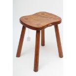 ROBERT THOMPSON, an adzed oak stool, the waisted rounded oblong top with carved mouse trademark in