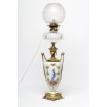 A VICTORIAN OIL LAMP, the slender ovoid glass body painted in polychrome enamels with a scantily
