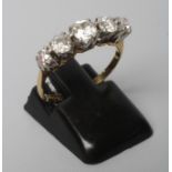 A FIVE STONE DIAMOND RING, the old mix cut stones claw set to a plain shank, stamped 18ct, PLA, size