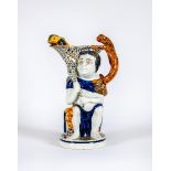 A RALPH WOOD PRATT TYPE PEARLWARE BACCHUS AND PAN JUG, c.1810, well moulded with Bacchus holding a