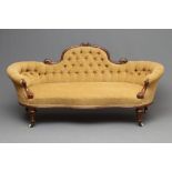 A VICTORIAN WALNUT SHOW FRAMED SOFA of serpentine form with rounded ends, button upholstered in a