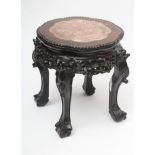 A CHINESE PADOUK WOOD JARDINIERE STAND, c.1900, the lobed and beaded circular top inset with red