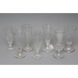 TWO SIMILAR DWARF GLASS ALE FLUTES, late 18th century, with wrythen moulded conical bowls on