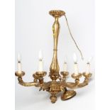 A CARVED GILT WOOD SIX LIGHT PENDANT, 20th century, the waisted baluster stem with foliate collar on
