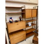 A TEAK LADDERAX TWO BAY UNIT comprising a three drawer chest with wooden lug handles, a cupboard