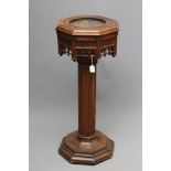 A VICTORIAN CARVED OAK PEDESTAL FONT of octagonal form, the moulded edged top with dished centre