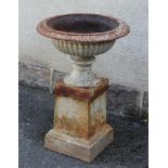 A VICTORIAN CAST IRON GARDEN URN, the shallow reeded bowl with everted tongue and dart moulded