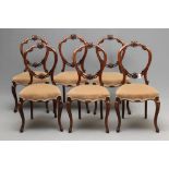 A SET OF SIX VICTORIAN WALNUT DINING CHAIRS of open balloon back form carved with foliate scrolls,