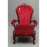 A VICTORIAN WALNUT SHOW FRAME EASY CHAIR of spoonback form button upholstered in crimson cut velvet,