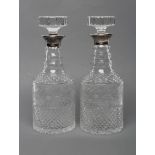 A PAIR OF SILVER MOUNTED TRIPLE RING NECK GLASS MALLET DECANTERS AND STOPPERS with diamond moulded