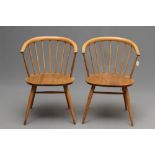 A PAIR OF ERCOL MODEL 449A CHAIRS IN BEECH AND ELM, the spindle backs with "cowhorn" bow rail, on